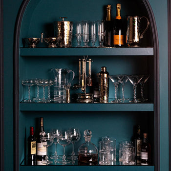 Large shelves in Juliska Teal showcase the metal and glass barware collections.