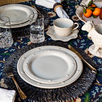 Berry and Thread Whitewash place setting on navy placemat.