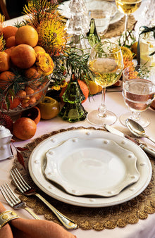 A Whitewash Berry & Thread Dinner and Salad plate sit on a gold placemat.