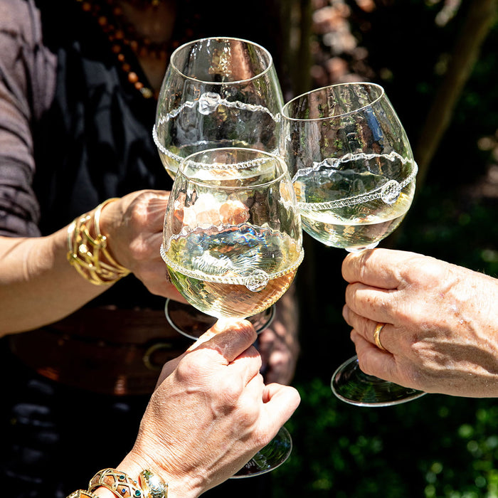 People cheersing with the graham white wine glass